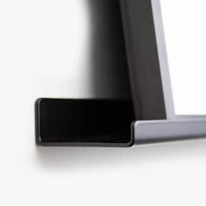 May include: A black metal shelf with a curved edge. The shelf is mounted to a white wall.
