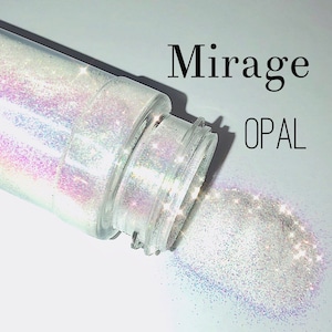 May include: A clear plastic jar with a white iridescent glitter inside. The jar is tipped over and the glitter is spilling out. The text "Mirage OPAL" is printed on the white background.