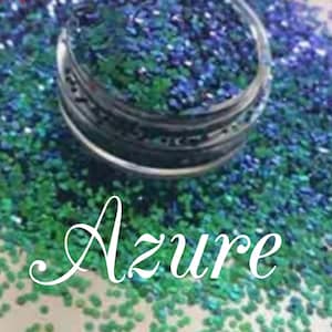 May include: A close-up of a jar of blue and green glitter, labeled "Azure".