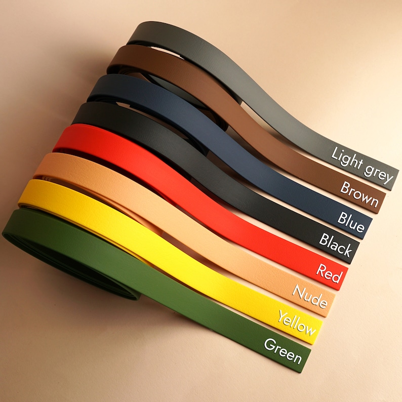 May include: A set of eight leather straps in different colors, including green, yellow, nude, red, black, blue, brown, and light grey. The straps are arranged in a fan shape with the color names written below each strap.