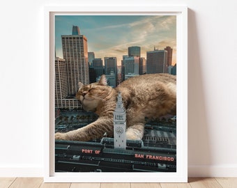 May include: A framed art print featuring a giant cat lounging on a rooftop with the San Francisco skyline in the background. The print includes the text "PORT OF SAN FRANCISCO". The cat is brown and tan, and the sky is a mix of blue and orange.