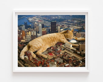 May include: A large ginger tabby cat is lying on top of a city skyline. The cat is sleeping and its paws are outstretched. The city is made up of tall buildings and roads.