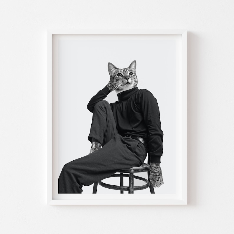 May include: A black and white photograph of a cat wearing a black turtleneck and trousers, sitting on a stool. The cat is looking upwards with a thoughtful expression.