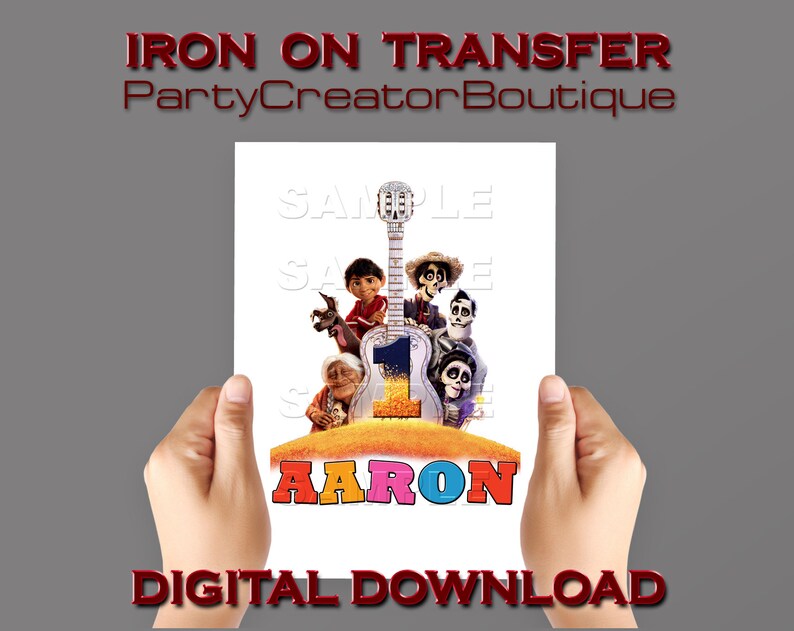 May include: Iron-on transfer featuring characters from the animated film Coco. The transfer includes a guitar, a skeleton, and a colourful background. The name "AARON" is written in large, colourful letters at the bottom of the transfer.