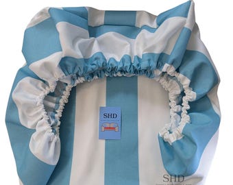 May include: A blue and white striped fabric with the text "CABANA 3" STRIPE AQUA" at the top. The fabric is gathered at the edges and has a small tag with the letters "SHD" and a sofa logo.
