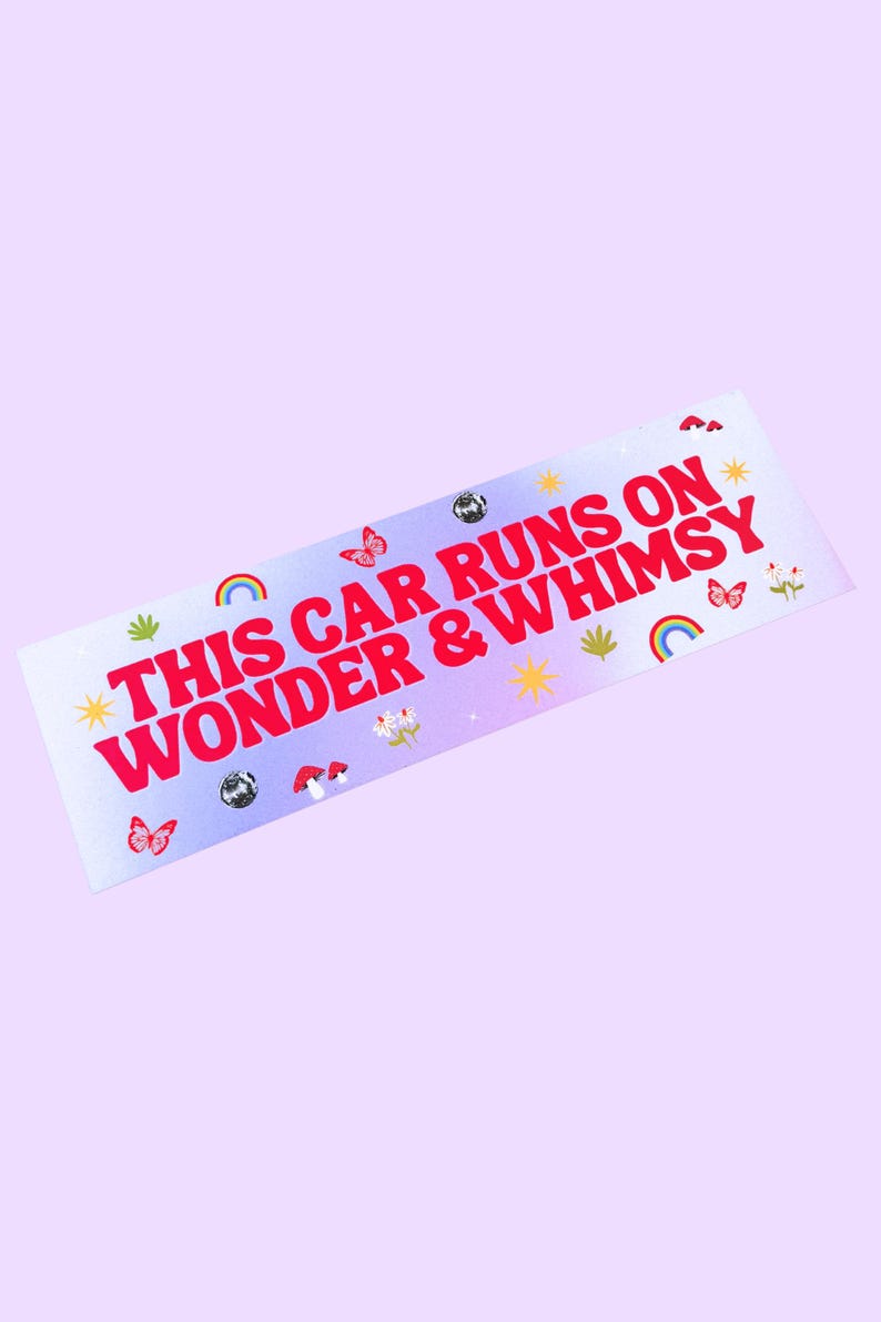 May include: A rectangular bumper sticker with a light purple background. The sticker has the text "THIS CAR RUNS ON WONDER & WHIMSY" in red. It is decorated with butterflies, rainbows, and stars.