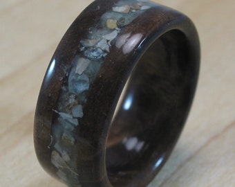 Walnut ring with seashell inlay and green glow powder