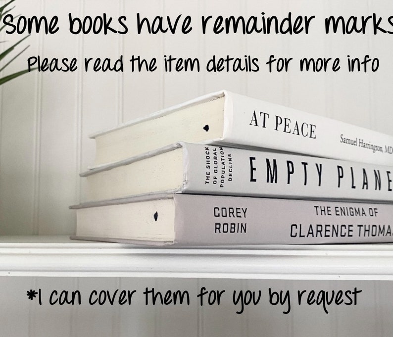 May include: Three white hardcover books stacked on a shelf. The top book is titled "At Peace" by Samuel Harrington, MD. The middle book is titled "Empty Plane". The bottom book is titled "The Enigma of" by Corey Robin and Clarence Thomas.