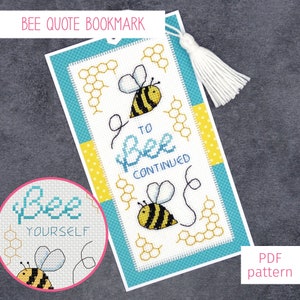 May include: A cross-stitch bookmark with a bee and honeycomb design. The bookmark features the text "To Bee Continued" and a bee with the text "Bee Yourself".