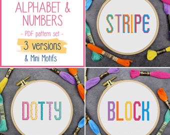 May include: A collection of cross-stitch patterns featuring the words "STRIPE", "DOTTY", and "BLOCK" in colorful, tall, and skinny lettering. The patterns are displayed in wooden embroidery hoops, surrounded by colorful embroidery floss. The image also includes text that reads "TALL SKINNY ALPHABET & NUMBERS - PDF pattern set - 3 versions & Mini Motifs."