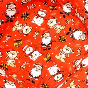May include: Two red fabric bowl cozies with a Christmas-themed pattern. The pattern includes Santa Claus, snowmen, and other festive characters. The cozies are square with a folded design.