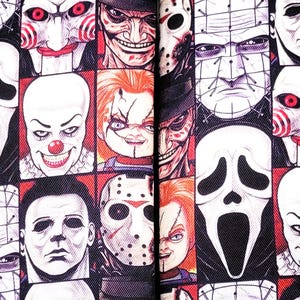 May include: Two black and white fabric wristlets with a repeating pattern of horror movie characters. The characters include Freddy Krueger, Jason Voorhees, Michael Myers, and more. The wristlets are approximately 8 inches long and 3 inches wide.
