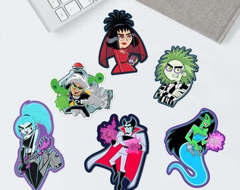 May include: A collection of colorful cartoon character stickers. The stickers feature characters with various hair colors and outfits. Some stickers have a black outline, and others have a white outline. The stickers are on a white surface.