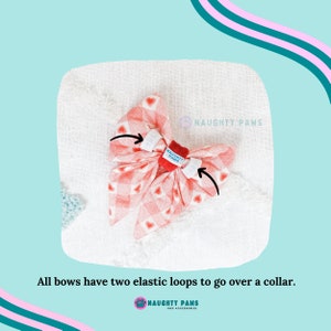 May include: A red and white gingham dog bow tie with heart patterns. The bow tie has two white elastic loops and a red center with the text "NAUGHTY PAWS". The text "All bows have two elastic loops to go over a collar" is also visible.