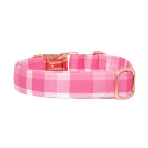 May include: Pink and white plaid dog collar with a rose gold buckle and D-ring.