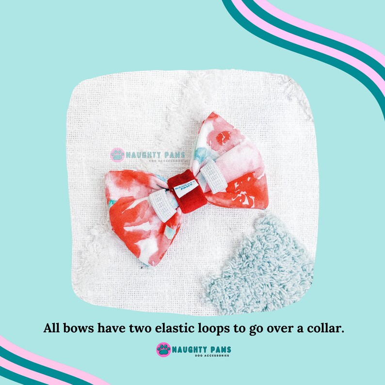 May include: A floral dog bow tie with red and white flowers, two elastic loops, and a red center. The bow tie is on a white textured surface with a light blue fluffy accent. Text: "All bows have two elastic loops to go over a collar."