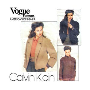 May include: Vogue Patterns American Designer Calvin Klein sewing pattern for a jacket. The pattern shows three different views of the jacket in brown, black, and beige.