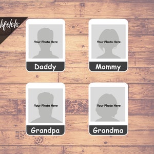May include: Four white photo frames with black borders and rounded corners. Each frame has a gray silhouette of a person's head and the words "Your Photo Here" above the silhouette. The frames are labeled "Daddy", "Mommy", "Grandpa", and "Grandma".