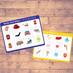 May include: Two colorful flashcards with images and words for learning short vowel sounds. The blue card has the words "tag", "hat", "pan", "can", "jam", "bat", "car", "rat", "bag", "van", "cat", "fan", "net". The yellow card has the words "hen", "red", "jet", "yes", "gem", "leg", "pen", "men", "web", "ten".