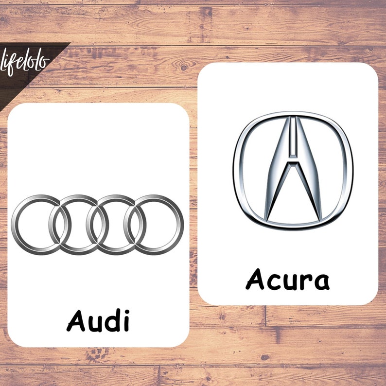 Puede incluir: Dos logotipos de coches en tarjetas blancas. La tarjeta de la izquierda muestra el logotipo de Audi, cuatro anillos plateados entrelazados. La tarjeta de la derecha muestra el logotipo de Acura, una A plateada dentro de un c&iacute;rculo plateado.