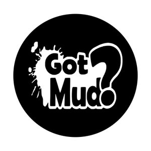 May include: A black circular graphic with the words "Got Mudo" in bold white letters, accompanied by a white splatter design and a large question mark. The design is simple and eye-catching.