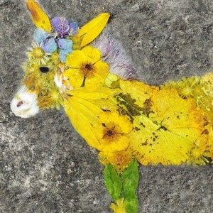 May include: A donkey made from pressed flowers and leaves. The donkey is yellow, green and blue. The donkey is wearing a flower crown.