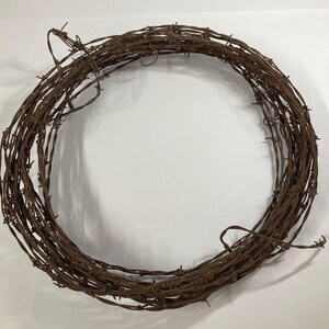 May include: A white ceramic mug with a black handle and the text "But First, Coffee" in a black, handwritten-style font. The mug is on a white surface.