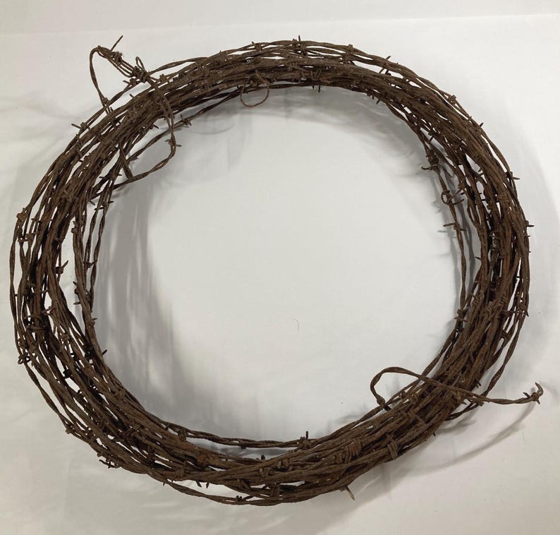 May include: A white ceramic mug with a black handle and the text "But First, Coffee" in a black, handwritten-style font. The mug is on a white surface.