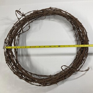 May include: A white ceramic mug with a black handle and the text "But First, Coffee" in a bold, black font. The mug is set against a neutral background, highlighting its simple design.