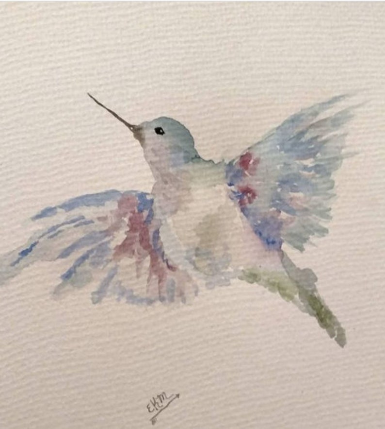 May include: Watercolour painting of a hummingbird in flight with blue, green and pink hues. The bird is depicted with its wings spread wide, creating a sense of motion. The background is a light beige.