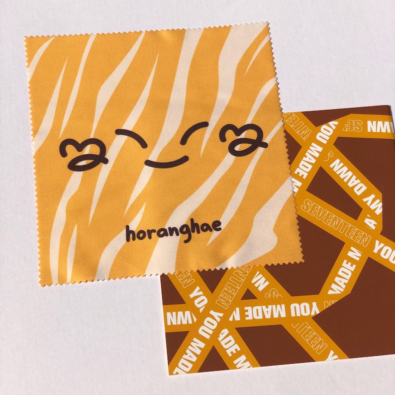 May include: A yellow and white striped microfiber cleaning cloth with a cartoon smiley face and the text "horanghae".