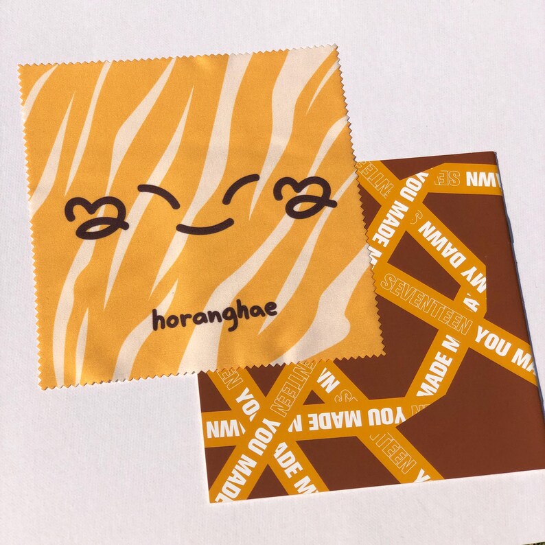 May include: A yellow and white striped microfiber cleaning cloth with a cartoon smiley face and the text "horanghae".