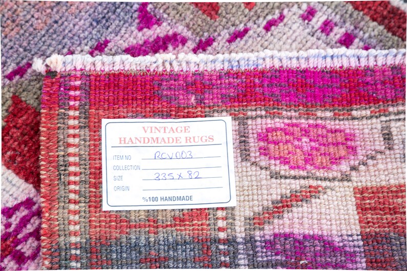 May include: A close-up of a vintage handmade rug tag with the text "Vintage Handmade Rugs", "Item No. RCV003", "Collection", "Size 335 x 82", and "Origin %100 Handmade".