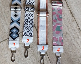 May include: Four different patterned fabric straps with silver clasps. The straps are numbered 1 through 4.