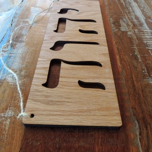 The sign is shown on a painted table with blue streaks vertically angled from the left.