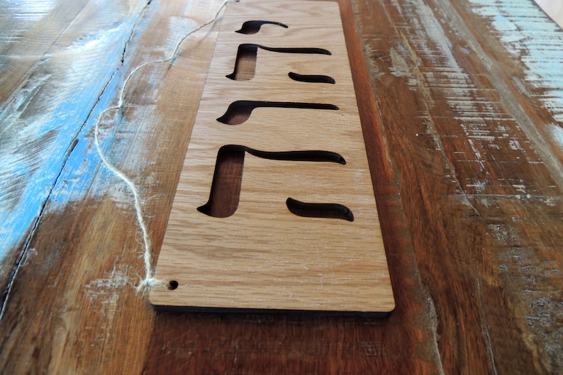The sign is shown on a painted table with blue streaks vertically angled from the left.