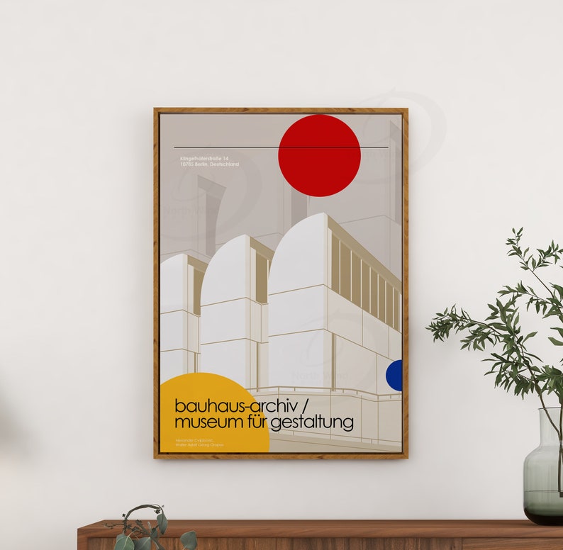 May include: A minimalist poster with a geometric design of a building in white, beige, and gray. The poster has a red circle at the top and a blue circle at the bottom. The text "bauhaus-archiv/museum f&uuml;r gestaltung" is in yellow at the bottom of the poster.