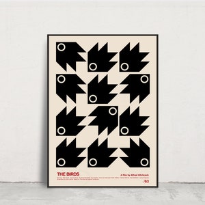 May include: A black and white minimalist poster with a geometric design of birds. The poster has the title "THE BIRDS" and the text "A film by Alfred Hitchcock" at the bottom. The poster is framed in black.