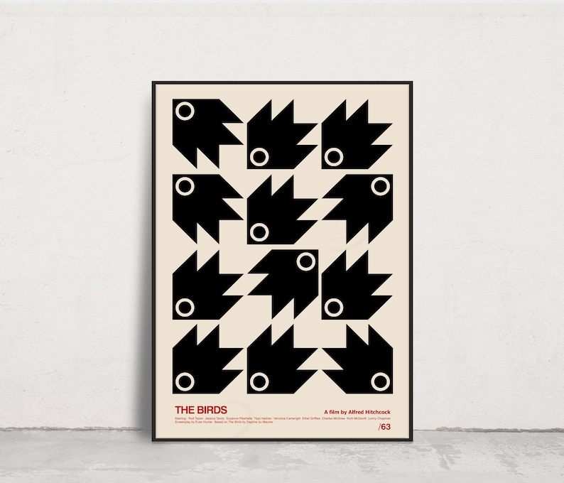 May include: A black and white minimalist poster with a geometric design of birds. The poster has the title "THE BIRDS" and the text "A film by Alfred Hitchcock" at the bottom. The poster is framed in black.