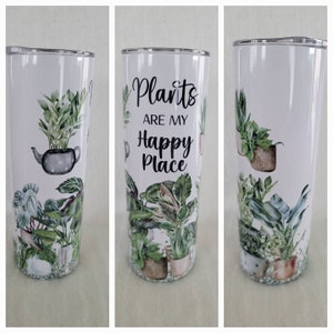May include: White stainless steel tumbler with a green and brown watercolour design of plants in pots. The tumbler has the text "Plants are my happy place" printed on it.