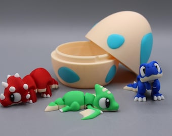 May include: A collection of colorful, miniature dinosaur figurines and an egg-shaped container. The dinosaurs are red, green, and blue, with white accents. The egg is beige with blue spots. The toys are likely for children.
