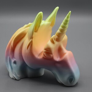 a small plastic toy of a unicorn's head