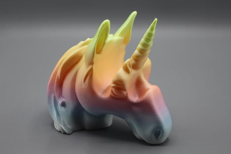 a small plastic toy of a unicorn's head