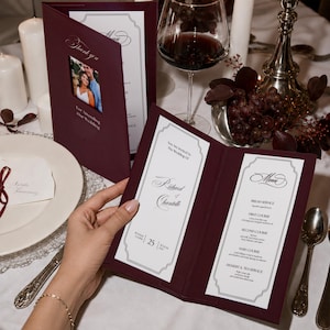 May include: A deep burgundy wedding menu card featuring a die-cut window with a photograph of a couple, white interior panels with black text, and elegant script fonts. The text includes "Thank you For Attending Our Wedding" and "Richard & Chantelle".