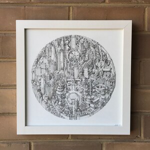 May include: A black and white pen and ink drawing of a city skyline, framed in a white frame. The drawing is in a circle and depicts a variety of buildings, including skyscrapers, churches, and other structures.