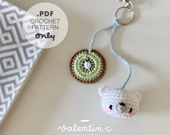 May include: A crochet kiwi fruit keychain with a white crocheted bear charm. The keychain is attached to a silver key ring. The text on the image reads '.PDF CROCHET PATTERN only'.