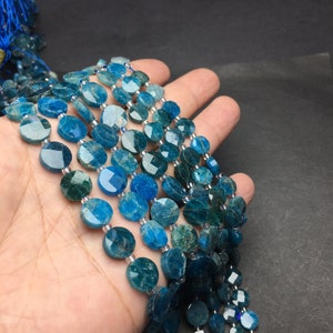 May include: A strand of blue apatite beads, faceted and round, with a slight variation in color from light to dark blue.