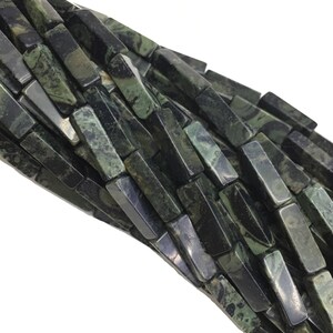 May include: A strand of dark green and black gemstone beads, each bead is a rectangular prism with a polished finish.