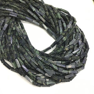 May include: A strand of dark green and black gemstone beads, each bead is a rectangular prism with a smooth, polished finish.