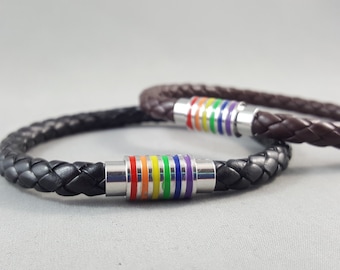 May include: Two braided leather bracelets with rainbow colored metal accents. The bracelets are black and brown.